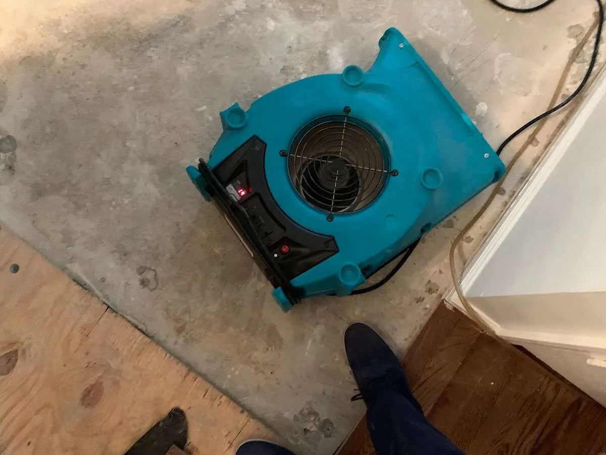 Air mover drying subfloor during Commercial Water Damage Restoration in West Carrollton